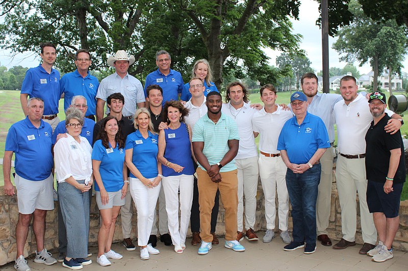 Kelly Hampton (front, from left), Jackie McPherson, Sharon Witcofski, Cynthia Coughlin, Antonio Greer, Jerry Walton; Dean Matthews (middle row, from left), John Hampton, Hudson Clark, Cade Fortin, Nathan Bax, Luke Hasz, Cameron Little, Brady Latham, Beaux Limmer, Mike Duley; Hayden Witcofski (back row, from left), Billy Witcofski, Benton County Sheriff Shawn Holloway and Todd and Melissa Fleeman, Law Enforcement Assistance Program directors and members with University of Arkansas football players, gather for a photo at the Benton County Sheriff's Cup 2023 cocktail event June 11 at Pinnacle Country Club in Rogers. 
(NWA Democrat-Gazette/Carin Schoppmeyer)