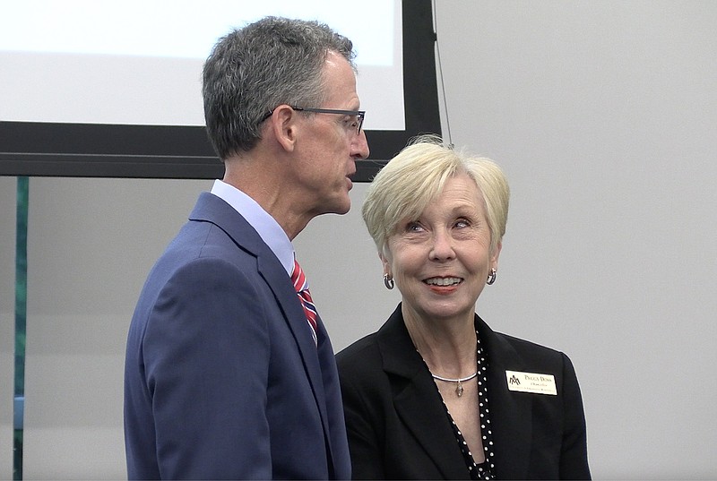 NPC President John Hogan, left, and UAM Chancellor Peggy Doss speak with each other following the announcement of the new Bachelor of Arts program in elementary education through the schools' partnership.  – Photo by Courtney Edwards of The Sentinel-Record