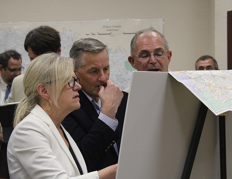 From left, ARDoT Director Lorie Tudor, U.S. Rep. Bruce Westerman and Arkansas Sen. Matt Stone look at a map of the path Interstate 69 will take through Arkansas during a meeting on highway projects at the El Dorado-Union County Chamber of Commerce on Monday, June 26. (Caitlan Butler/News-Times)