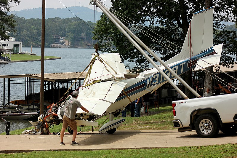 Workers stabilize the wreckage of a Cessna 177 Cardinal that crashed into Lake Hamilton after removing it from the lake Tuesday morning. - Photo by James Leigh of The Sentinel-Record