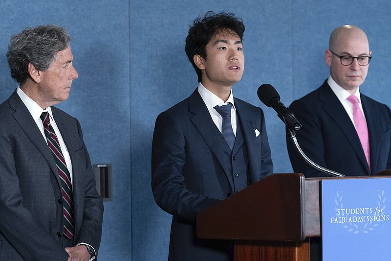 Berkeley University student Calvin Yang, center flanked by Edward Blum, left, and Adam Mortaraw, right, speaks during a news conference on Supreme Court affirmative action in college admissions decision at the Press Club in Washington, Thursday, June 29, 2023. (AP Photo/Jose Luis Magana)