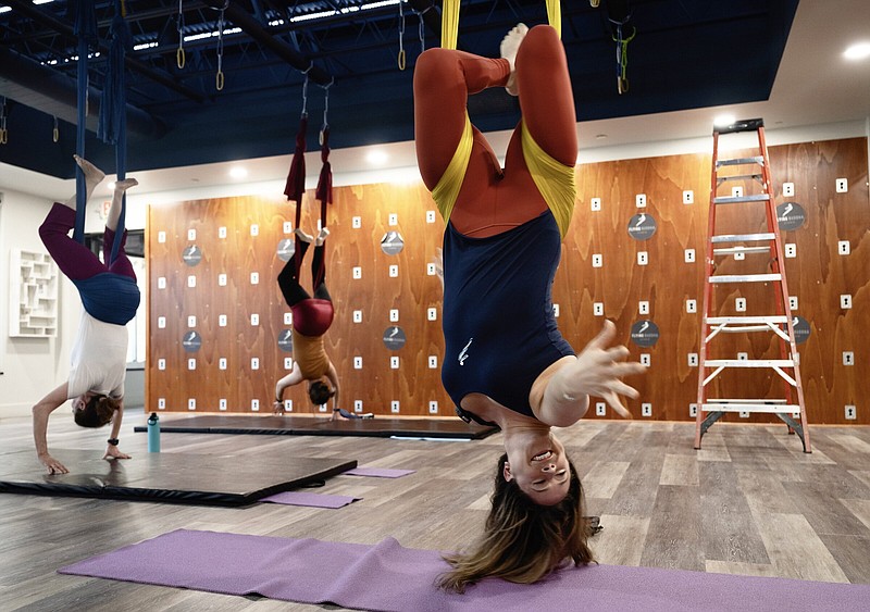 Instructor Sarah Rehman leads an aerial yoga session at the Flying Buddha Studio in Gaithersburg, Md. MUST CREDIT: Washington Post photo by Marvin Joseph.