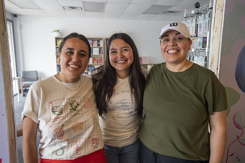 Sandra Carrasco Quezada, (left) owner of Bites and Bowls and Diana Dominguez, owner of Mas Libritos Bookstore and Laura Carrasco Quezad (right) Saturday July 1, 2023. Bites and Bowls recently expanded and is celebrating five years of being open. Meanwhile Mas Libritos, a bookseller that provides titles from Hispanic and other diverse-background authors not typically available in our public libraries and stores, is opening its very first storefront (right next to Bites and Bowls) after a few seasons as a pop-up shop.  Visit nwaonline.com/photo for today's photo gallery.   (NWA Democrat-Gazette/J.T. Wampler)