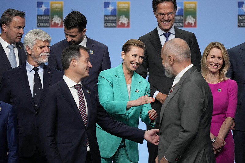 Denmark's Prime Minister Mette Frederiksen, center, speaks with Albania's Prime Minister Edi Rama, second right, during a group photo at a NATO summit in Vilnius, Lithuania, Tuesday, July 11, 2023. NATO's summit began Tuesday with fresh momentum after Turkey withdrew its objections to Sweden joining the alliance, a step toward the unity that Western leaders have been eager to demonstrate in the face of Russia's invasion of Ukraine. (AP Photo/Pavel Golovkin)