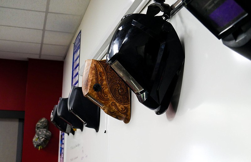 Welding masks hang on the whiteboard Wednesday in a classroom at the Goodwill Training and Education Center in Springdale. The welding class will provide students with the opportunity to earn welding certifications. Visit nwaonline.com/photos for todays photo gallery.

(NWA Democrat-Gazette/Caleb Grieger)