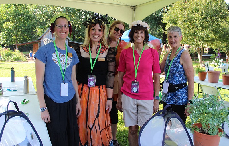 Laura Stilwell (from left), LeAnn Lee(cq), Kathleen Holloway, Kathy Launder and Elaine Dominguez, Botanical Garden of the Ozarks volunteers, help out at the Firefly Fling Festival on July 15 at the garden in Fayetteville.
(NWA Democrat-Gazette/Carin Schoppmeyer)