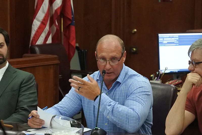 Crawford County Judge Chris Keith, center, speaks while Gentry Wahlmeier, an attorney for the county, left, and Mark Shaffer, justice of the peace for the county's District 6, right, listen during the county Quorum Court meeting Monday. 
(River Valley Democrat-Gazette/Thomas Saccente)