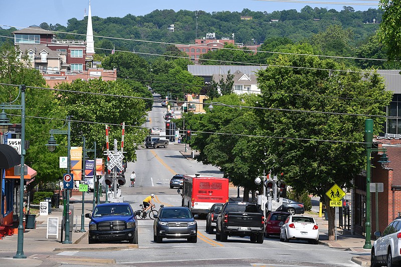 Traffic passes on May 26 along Dickson Street in Fayetteville. The Downtown Fayetteville Coalition is asking for money from the city to get started on its mission to host events and programming and promote downtown.
(File photo/NWA Democrat-Gazette/Andy Shupe)