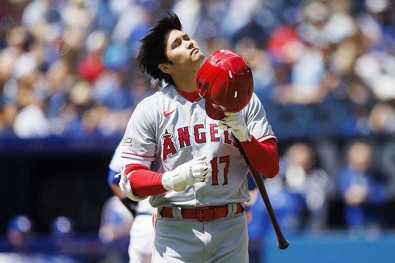 Los Angeles Angels' Shohei Ohtani flips his hair as he fixes his helmet during his at-bat in the first inning against the Toronto Blue Jays Sunday in Toronto. - Photo by Cole Burston of The Canadian Press via The Associated Press