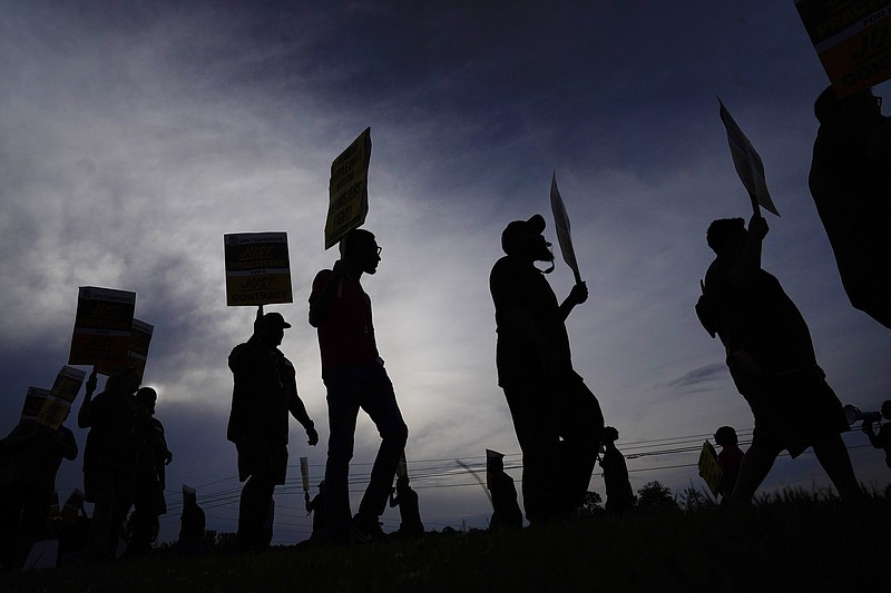 FILE - UPS teamsters and workers hold a rally, Friday, July 21, 2023, in Atlanta, as a national strike deadline nears.  UPS has reached a contract agreement with its 340,000-person strong union Tuesday, July 25, averting a strike that had the potential to disrupt logistics nationwide for businesses and households alike.   (AP Photo/Brynn Anderson, File)