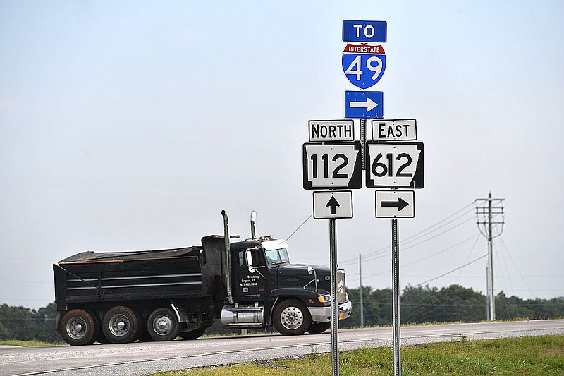 A dump truck heads east Friday, July 28, 2023, onto Arkansas 612 at Arkansas 112 north of Elm Springs in Springdale. Regional Planners are pursuing $50 million in federal grants to help pay for two major transportation projects, another section of the Springdale Northern Bypass and improvements to Arkansas 112. Visit nwaonline.com/photo for today's photo gallery. 
(NWA Democrat-Gazette/Andy Shupe)