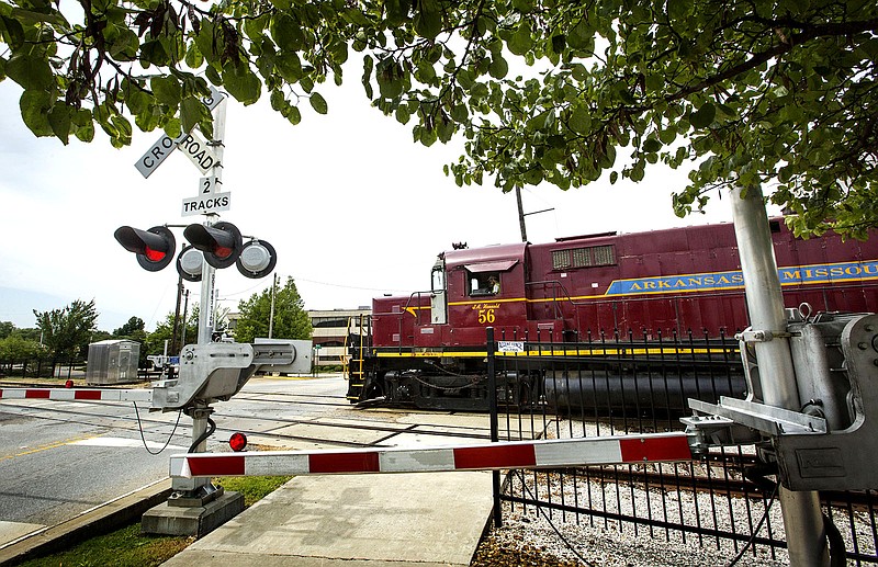 NWA Democrat-Gazette/BEN GOFF @NWABENGOFF
A Arkansas & Missouri Railroad train passes Thursday, Aug. 22, 2019, at the crossing on East Emma Avenue in Springdale.