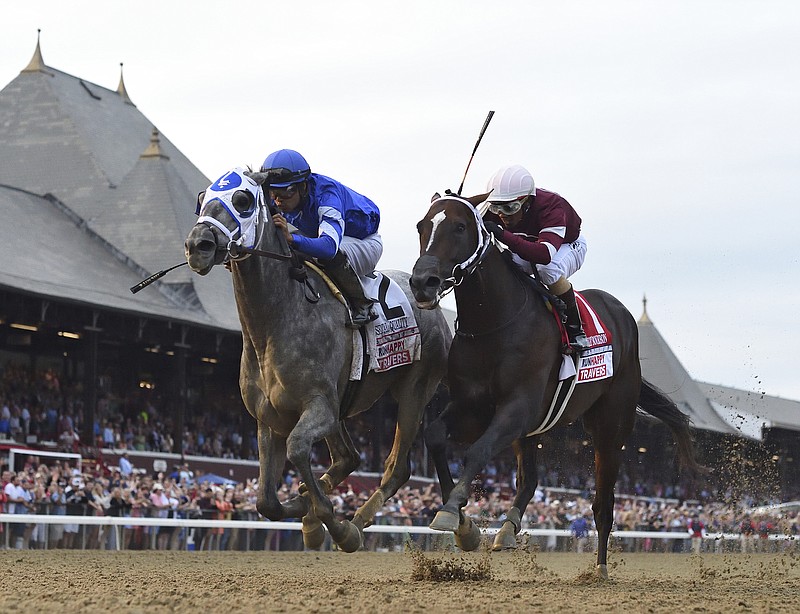 Essential Quality, left, with jockey Luis Saez, holds off Midnight Bourbon, with Ricardo Santana Jr., to win the Travers Stakes Aug. 28, 2021, at Saratoga Race Course in Saratoga Springs, N.Y. - Photo by Adam Coglianese of The Associated Press