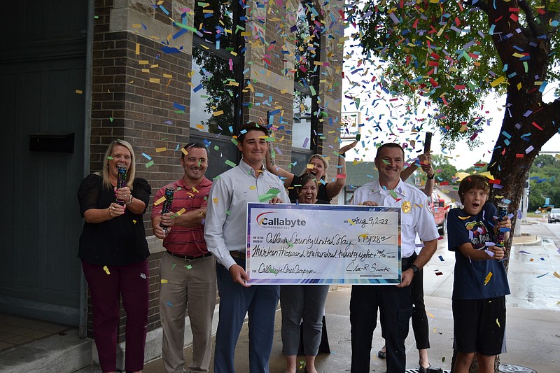 Andrea Merritt/Fulton Sun photo: 
The Callaway County United Way pops biodegradable confetti after receiving a $13,128 donation from Callabyte Technology on Aug. 9, 2023.