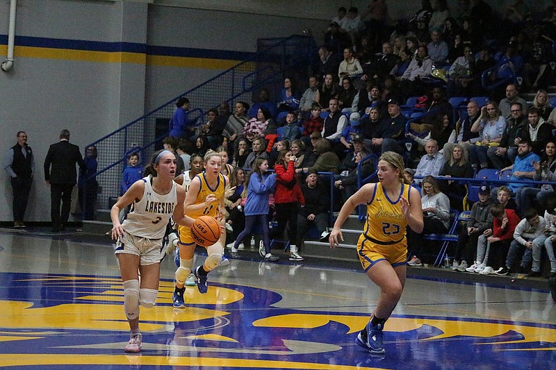 Lakeside's Amelia Rogers (3) dribbles up the court while Sheridan's Brooklyn Rowe (23) chases Feb. 10 at Lakeside Athletic Complex. - File photo by The Sentinel-Record
