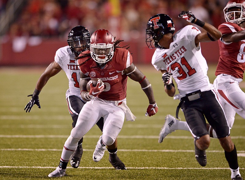 Alex Collins, Arkansas running back, evades Texas Tech safety Keenon Ward (15) and cornerback Justis Nelson in the fourth quarter on Saturday, Sept. 19, 2015, during the game in Razorback Stadium in Fayetteville. - Photo by Ben Goff of NWA Democrat-Gazette