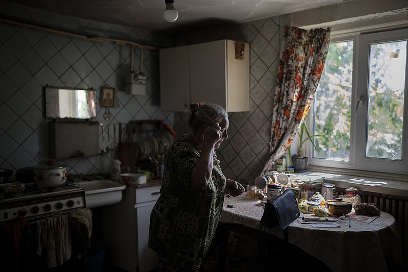 Nina Sytnikova, 76, packs her belongings while being evacuated in Kupyansk, Ukraine, Monday, Aug. 14, 2023. Ukrainian Red Cross teams continued to respond to evacuation requests from civilians living close to the northeast frontline where Russia has recently stepped up attacks. (AP Photo/Bram Janssen)
