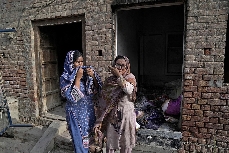 Christian women weep after seeing their homes vandalized by angry Muslim mob in Jaranwala near Faisalabad, Pakistan, Thursday, Aug. 17, 2023. Muslims in eastern Pakistan went on a rampage Wednesday over allegations that a Christian man had desecrated the Quran, demolishing the man's house, burning churches and damaging several other homes, police and local Christians said. (AP Photo/K.M. Chaudary)