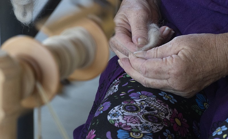 Kathleen McGill uses a wheel to make yarn during a monthly meeting of the Wool and Wheel Handspinners group at Prairie Grove Battlefield State Park. Spinning and lace making demonstrations will be part of a weekend of Civil War related tours and activities Friday through Sunday at the park west of Fayetteville.  (NWA Democrat-Gazette File photo/J.T. Wampler)