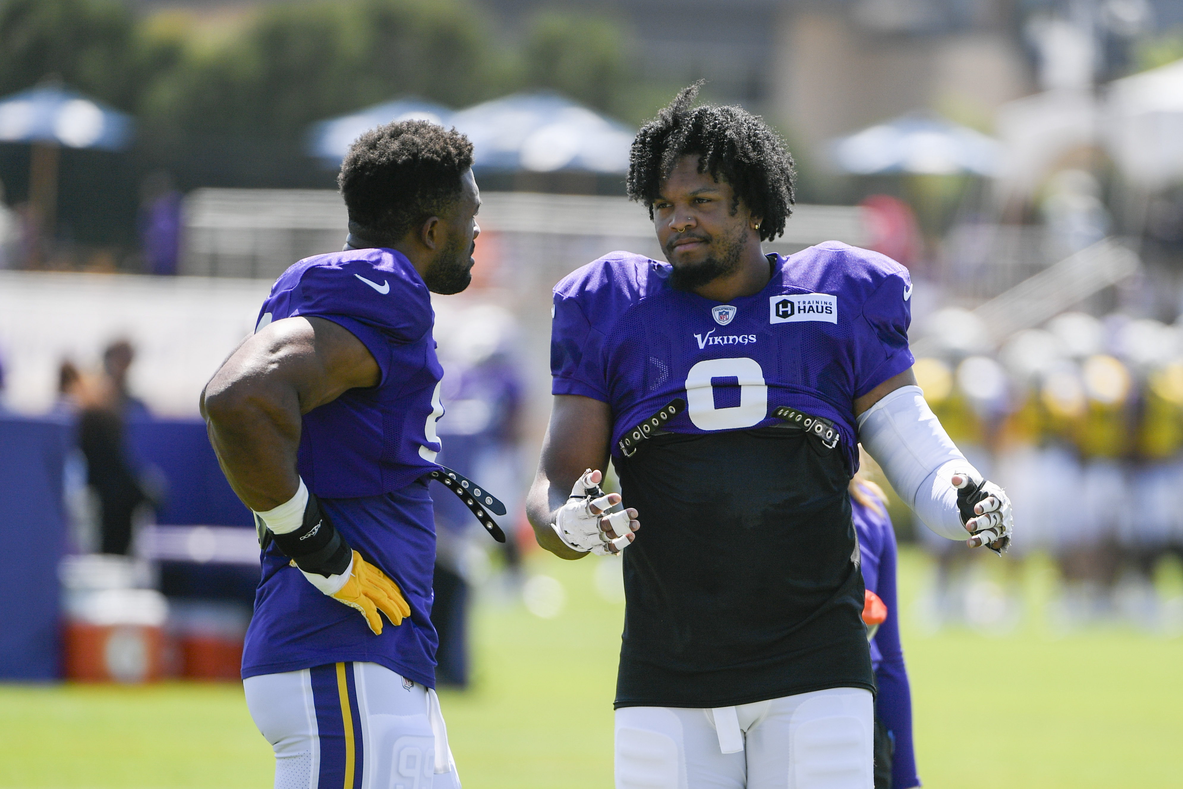 Seattle Seahawks wide receiver Jaxon Smith-Njigba (11) talks with  teammates, including running back Marcus Cooper (