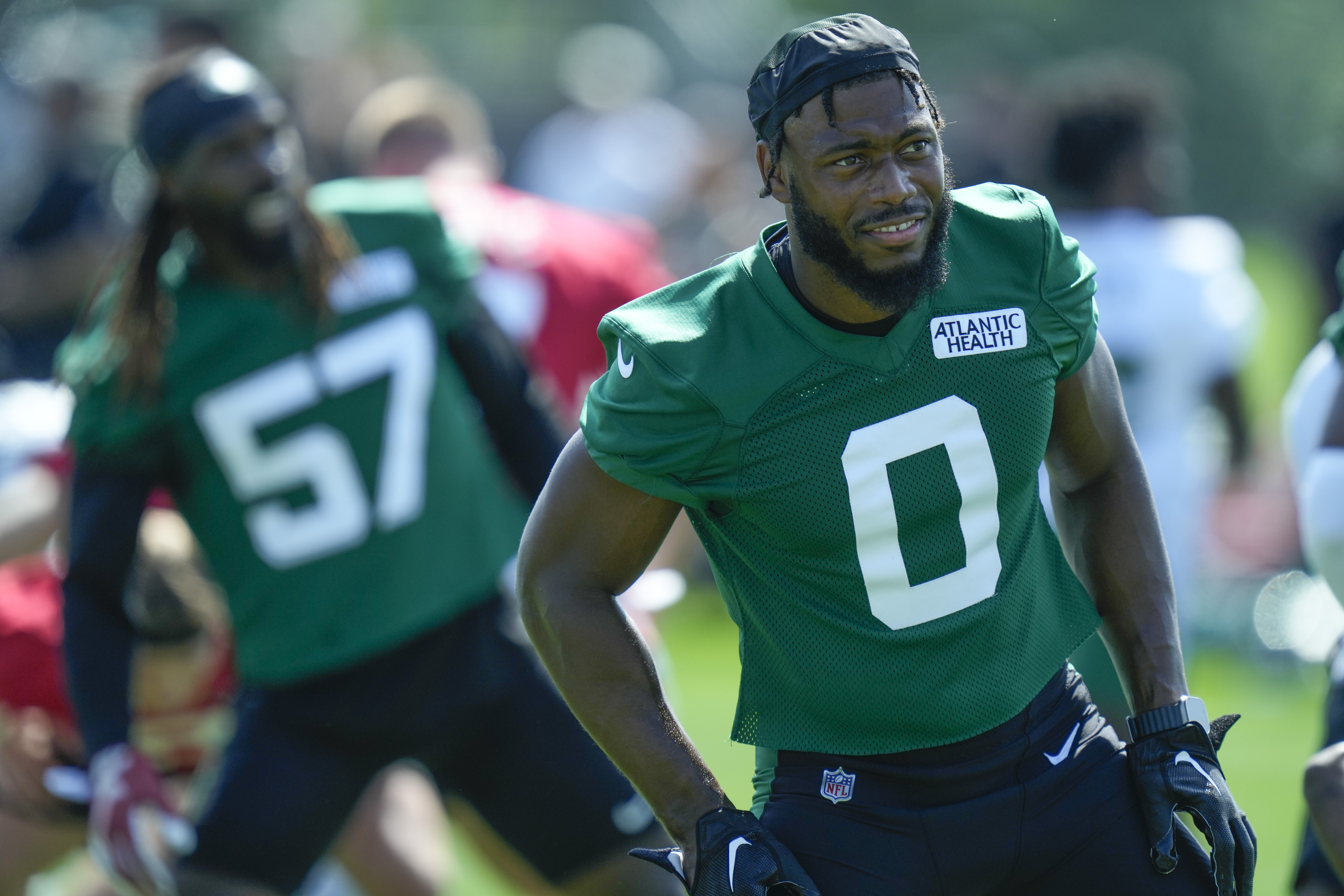 Los Angeles Rams linebacker Byron Young (0) runs during the first half of  an NFL preseason