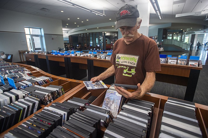 Tom Dorais of Kingston looks through movies on DVD on Monday at the Fayetteville Public Library. Visit nwaonline.com/photo for todays photo gallery.

(NWA Democrat-Gazette/J.T. Wampler)