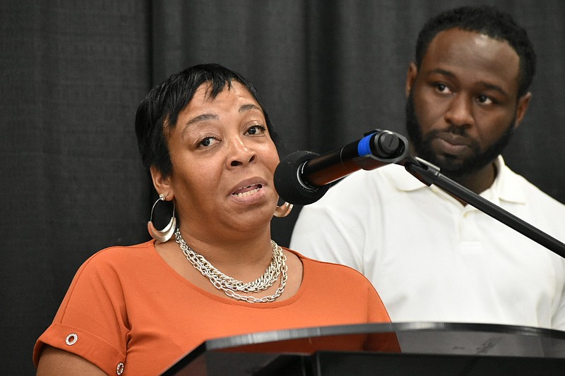 Kimberly Burrell, who lost an 18-year-old son to gun violence in 2009, speaks as Philadelphia Group Violence Intervention director Deion Sumpter listens Tuesday. (Pine Bluff Commercial/I.C. Murrell)