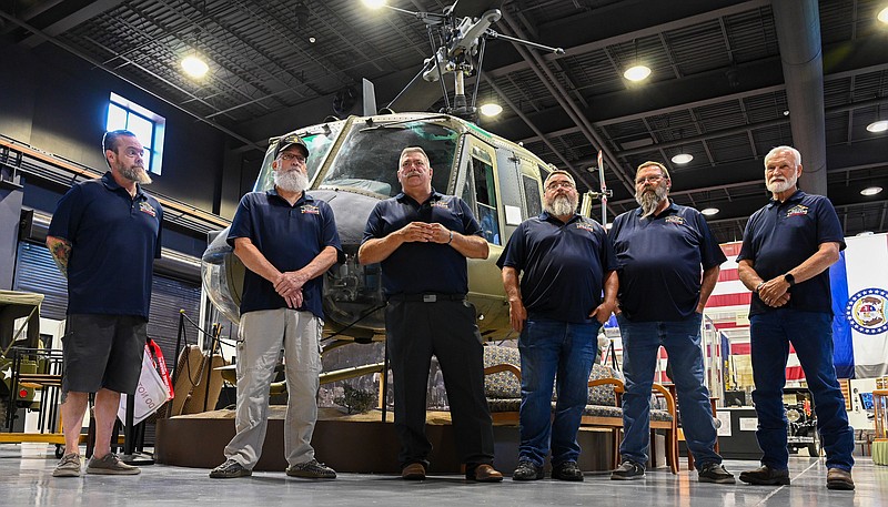 Julie Smith/News Tribune
While standing in front of a Vietnam-era Huey helicopter, Mid-MO Veterans Express Director Darren "Bear" Reuter, third from left, talks about the vision for the new organization and about the goal of serving Vietnam Veterans. Reuter was joined by members of the founding committee for a press conference at the Museum of Missouri Military History to announce the formation of MMVE and explained how the public can support it. With Reuter are, from left: Daniel "Frenchie" Levasseur, Jon Morgan, Scott Farley, Jim Rosenberg and Rep. Jim Schulte. MMVE will bus Vietnam Veterans to Perryville to see the Vietnam Wall replica, treat them to lunch at a nearby American Legion post before returning to Jefferson City.
