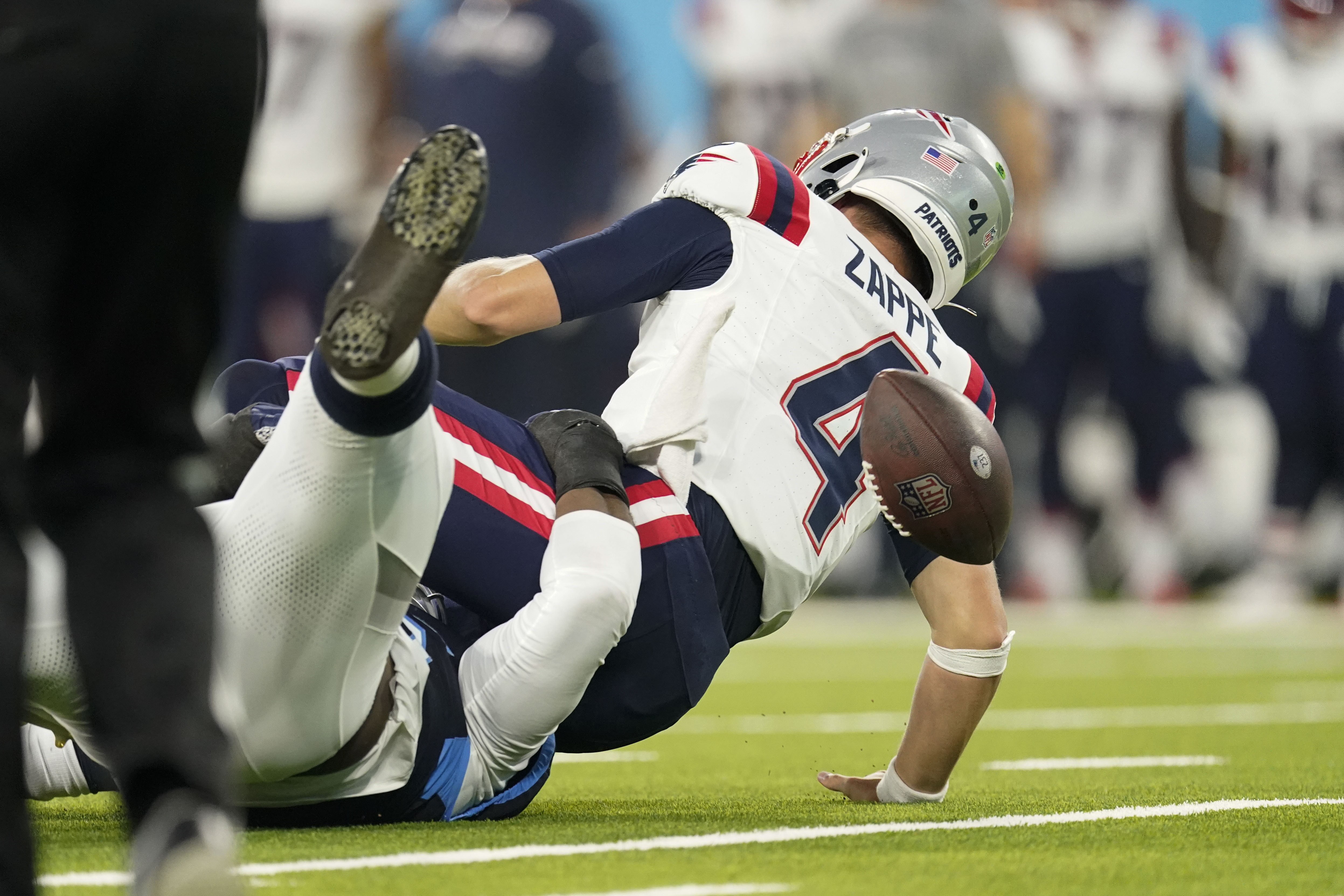 Tennessee Titans running back Julius Chestnut fumbles as he is hit by New  England Patriots defensive end Jeremiah Pharms Jr. in the first half of an  NFL preseason football game Friday, Aug.