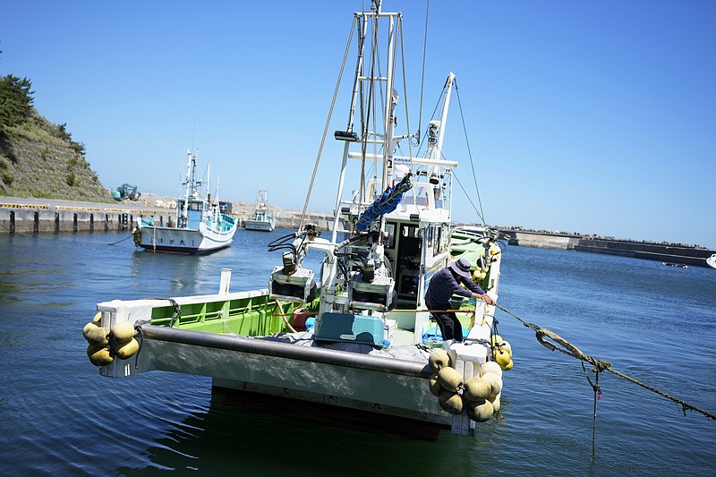 A fisherman anchors his fishing boat at Numanouchi port, Iwaki, northeastern Japan, near the Fukushima Daiichi nuclear power plant, damaged by a massive March 11, 2011, earthquake and tsunami, on Friday, Aug. 25, 2023. Fish auction prices at a port south of the Fukushima Daiichi nuclear power plant Friday somehow dipped amid uncertainty about how consumers may respond a day after release to sea of treated and diluted radioactive wastewater began despite protests at home and in neighboring countries. (AP Photo/Eugene Hoshiko)