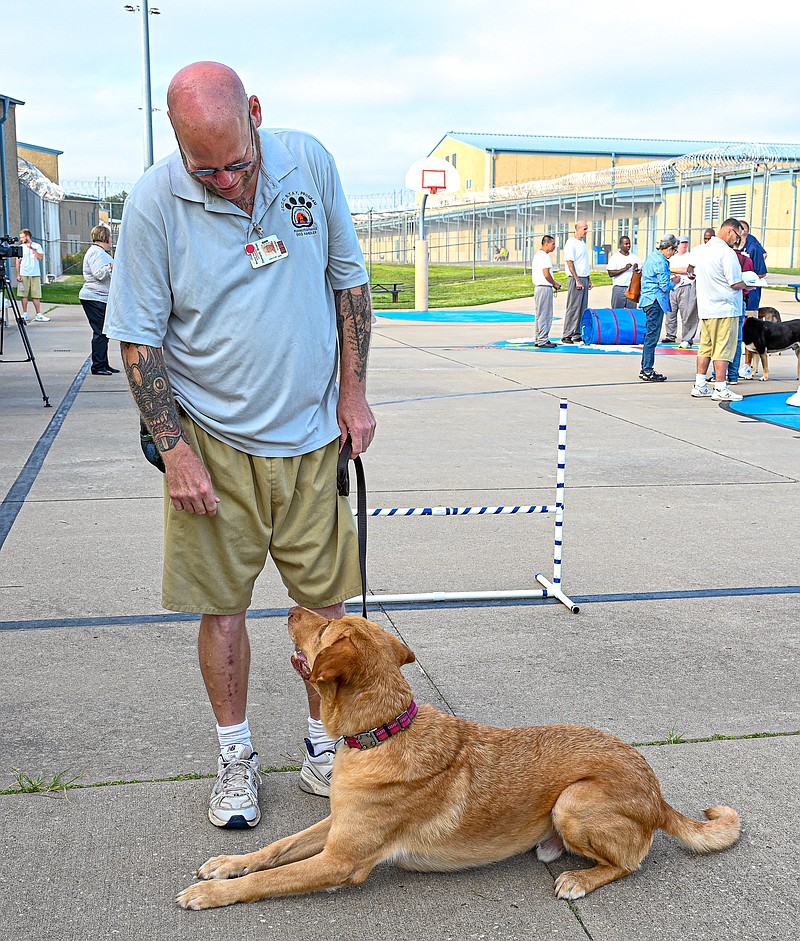 Julie Smith/News Tribune photo: 
Handler Brian Damanti with his canine charge Milton, with whom he's been working over the last several weeks to train for the Puppies for Parole program at Jefferson City Correctional Center.