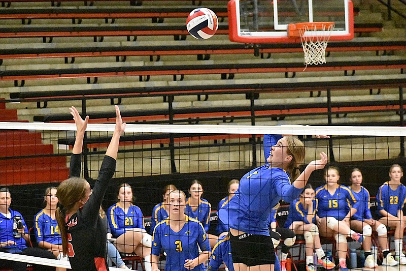 Abby Martin (4) of Sheridan goes for a kill against Jacey Insley (6) of White Hall on Thursday at Bert Honey Gymnasium. (Pine Bluff Commercial/I.C. Murrell)