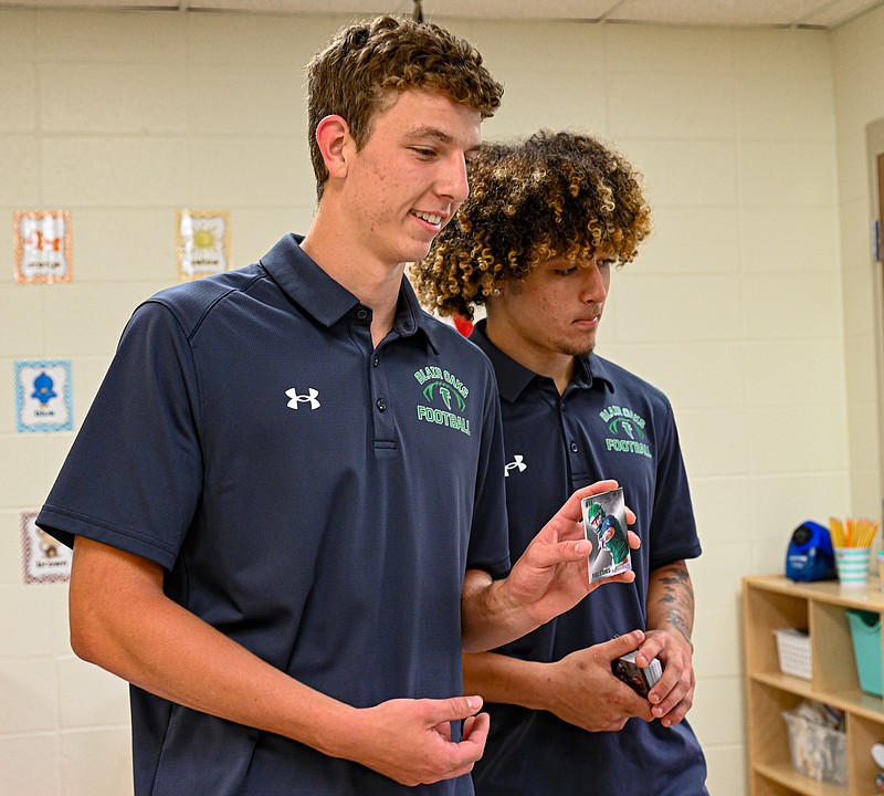 Blair Oaks football seniors hand out trading cards to youngest fans ...