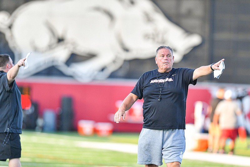 Arkansas head coach Sam Pittman signals to his team Aug. 4 during the Razorbacks first practice of fall camp at the Fred W. Smith Football Center in Fayetteville. - Photo by Hank Layton of NWA Democrat-Gazette