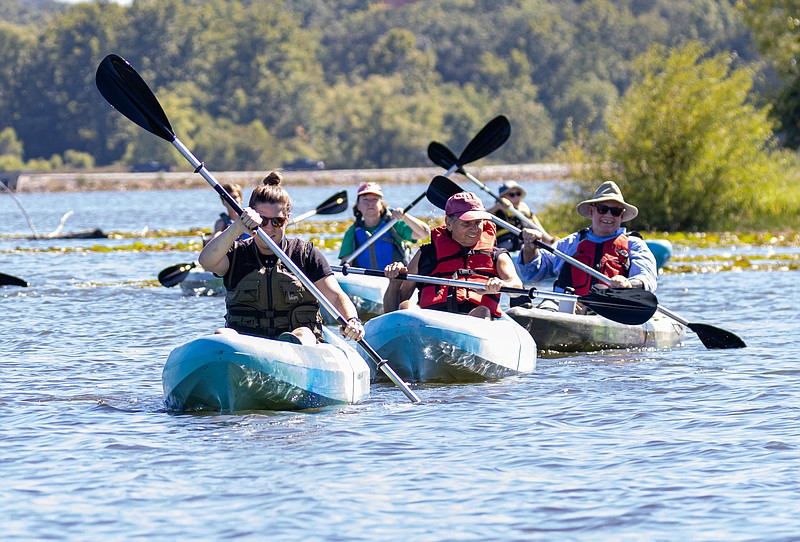 Josh Cobb/News Tribune. Sarah Easton (left) from the Missouri Department of Conservation leads a group of kayakers during the Missouri Department of Conservations Kayaking event at Binder Lake on Friday afternoon. Participants in the event got to learn about the techniques and equipment needed to safely kayak in Missouri before having the opportunity to paddle out on the water themselves.