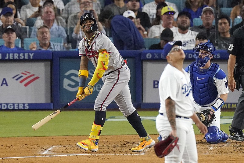 Atlanta Braves' Ronald Acuna Jr., left, heads to first after hitting a solo home run as Los Angeles Dodgers starting pitcher Julio Urias, center, and catcher Will Smith watch during the third inning Friday in Los Angeles. - Photo by Mark J. Terrill of The Associated Press