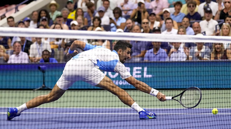 Novak Djokovic, of Serbia, can't catch up with a drop shot from Ben Shelton, of the United States, during the men's singles semifinals of the U.S. Open Friday in New York. - Photo by Charles Krupa of The Associated Press