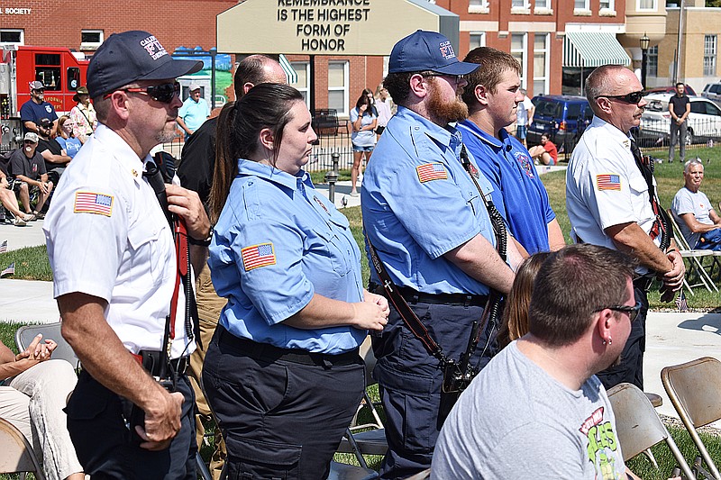 Democrat photo/Garrett Fuller — Members of the California Fire Department stand while firefighters and other first responders are recognized Sunday during the Moniteau County 4-H Day of Service committee's Honoring Our Heroes ceremony in Latham Family Memorial Park. Pictured, from left, are: Jay Fortner, Samantha Risinger, Brandon Embry, Tanner Embry (junior firefighter) and Chief Brad Friedmeyer.