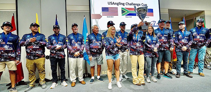 Team USA member Michelle Halaba lifts the trophy after the team defeated South Africa and the Philippines in the USAngling Challenge Cup over the weekend on Lake Hamilton. - Submitted photo