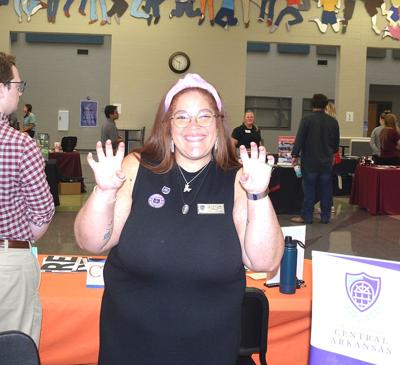Marc Hayot/Herald-Leader University of Central Arkansas recruiter Caitlin Straw does her best impression of her school's mascot at the college, technical and military fair on Thursday, Sept. 14, at the high school cafeteria.