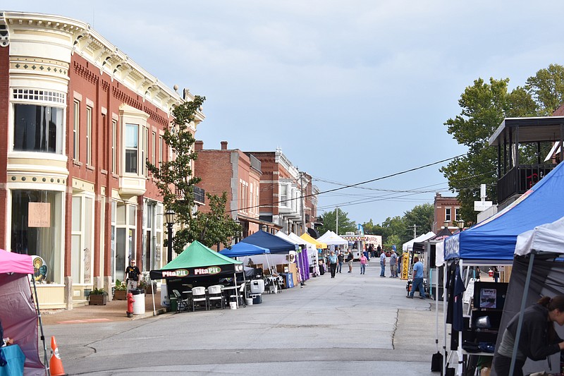 Democrat photo/Garrett Fuller — High Street is bare Saturday morning before the hustle and bustle of the 33rd annual Ozark Ham and Turkey Festival begins. Vendors used the time to finish setting up their booths after early morning showers moved through.