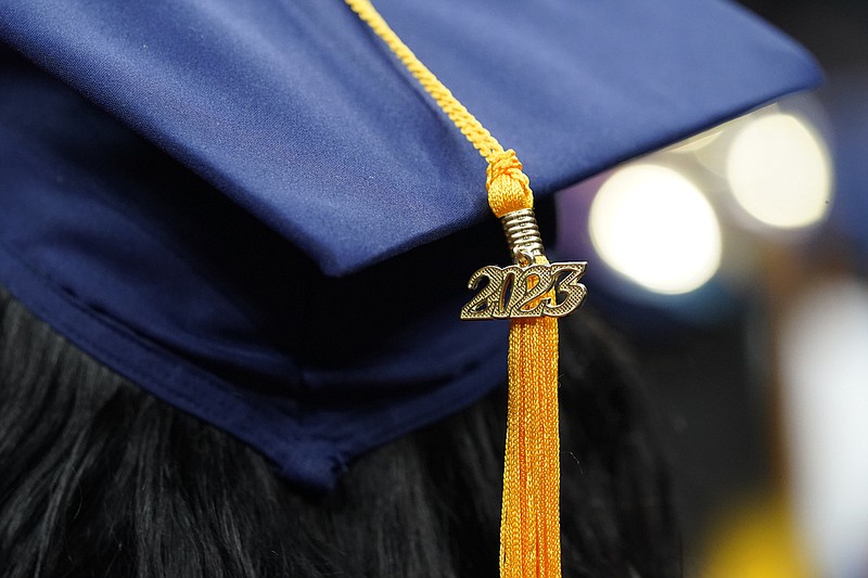 FILE - A tassel with 2023 on it rests on a graduation cap as students walk in a procession for Howard University's commencement in Washington, Saturday, May 13, 2023. The return of federal student loan payments in October has the potential to derail your finances, especially if youre already struggling with credit card payments. (AP Photo/Alex Brandon, File)