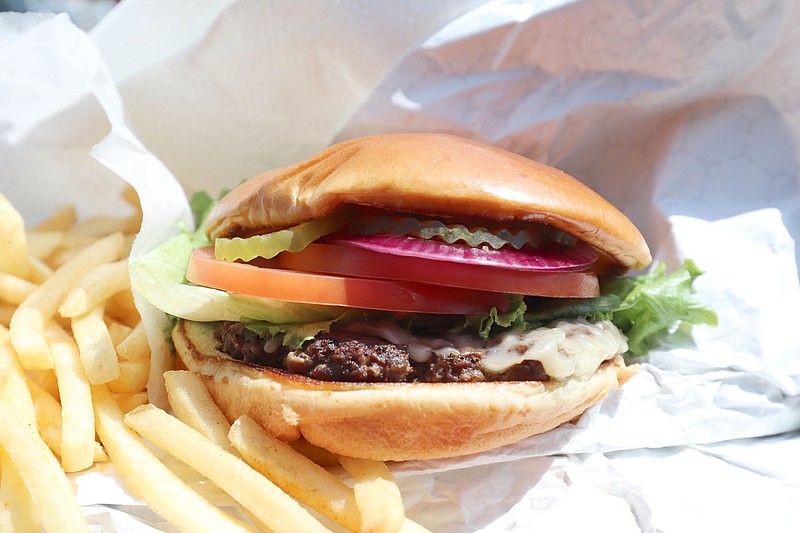 A nice, substantial grill-flattened round of beef is seared and topped with your choice of cheese and the toasted and seedless bun carries a payload of fresh slices of tomato, lettuce, pickles, and red onion, which produces a nice satisfying crunch to each bite. 
(Courtesy Photo/Kat Robinson)