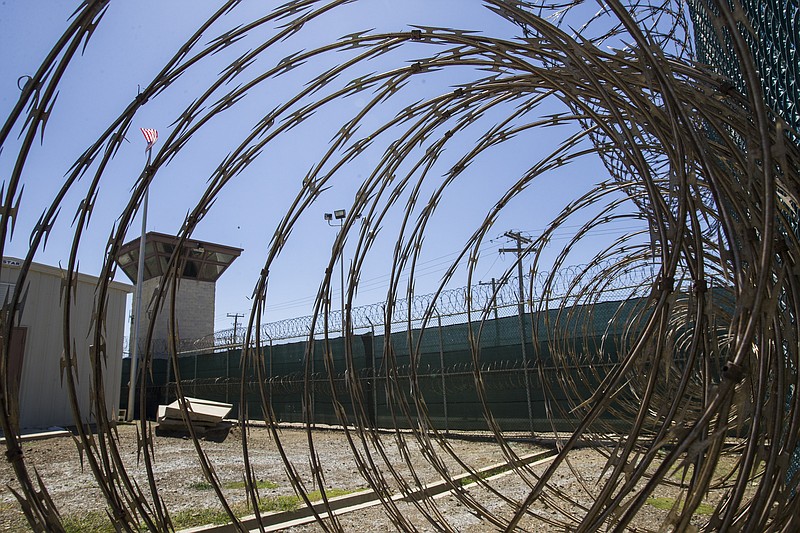 FILE - In this April 17, 2019, photo, reviewed by U.S. military officials, the control tower is seen through the razor wire inside the Camp VI detention facility in Guantanamo Bay Naval Base, Cuba. A military medical panel has concluded that one of the five 9/11 defendants held at Guantanamo Bay has been rendered delusional and psychotic by the torture he underwent years ago while in CIA custody.  A military judge is expected to rule as soon as Thursday whether al-Shibhs mental issues render him incompetent to take part in the proceedings against him. (AP Photo/Alex Brandon, File)