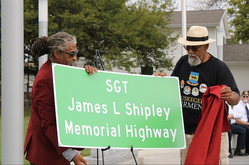 Kaden Quinn/California Democrat photo: 
From left, Timothy Shipley and his brother-in-law unveil the "Sgt. James L. Shipley Memorial Highway" signs.