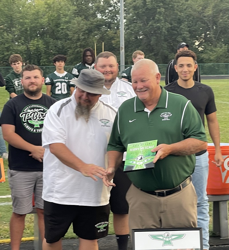 Terry Metcalf receives his 2023-24 North Callaway Hall of Fame plaque from Thunderbirds activities director/football coach Kevin O'Neal Friday at North Callaway's football field in Kingdom City. (Robby Campbell/Fulton Sun)