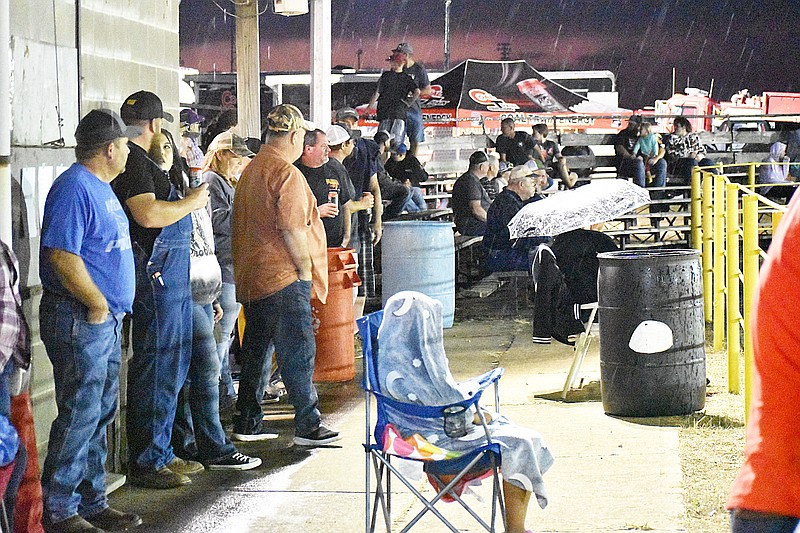 Democrat photo/Garrett Fuller — While most took shelter from the rain Saturday night during the Russellville High School FFA Chapter's truck and tractor pull, some weathered the rain for a better view of trucks and tractors pulling sleds at the Russellville Lions Club grounds.