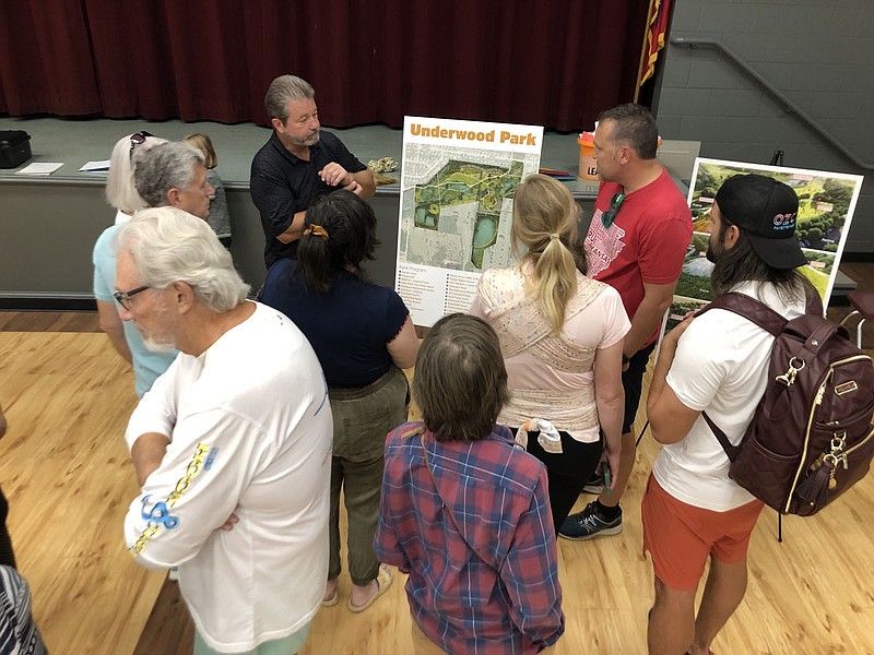 Residents gather Wednesday at Holcomb Elementary School in Fayetteville to go over a proposed plan for the in-development Underwood Park west of Deane Solomon Road. The city is taking resident feedback on a draft of the plan.

(NWA Democrat-Gazette/Stacy Ryburn)
