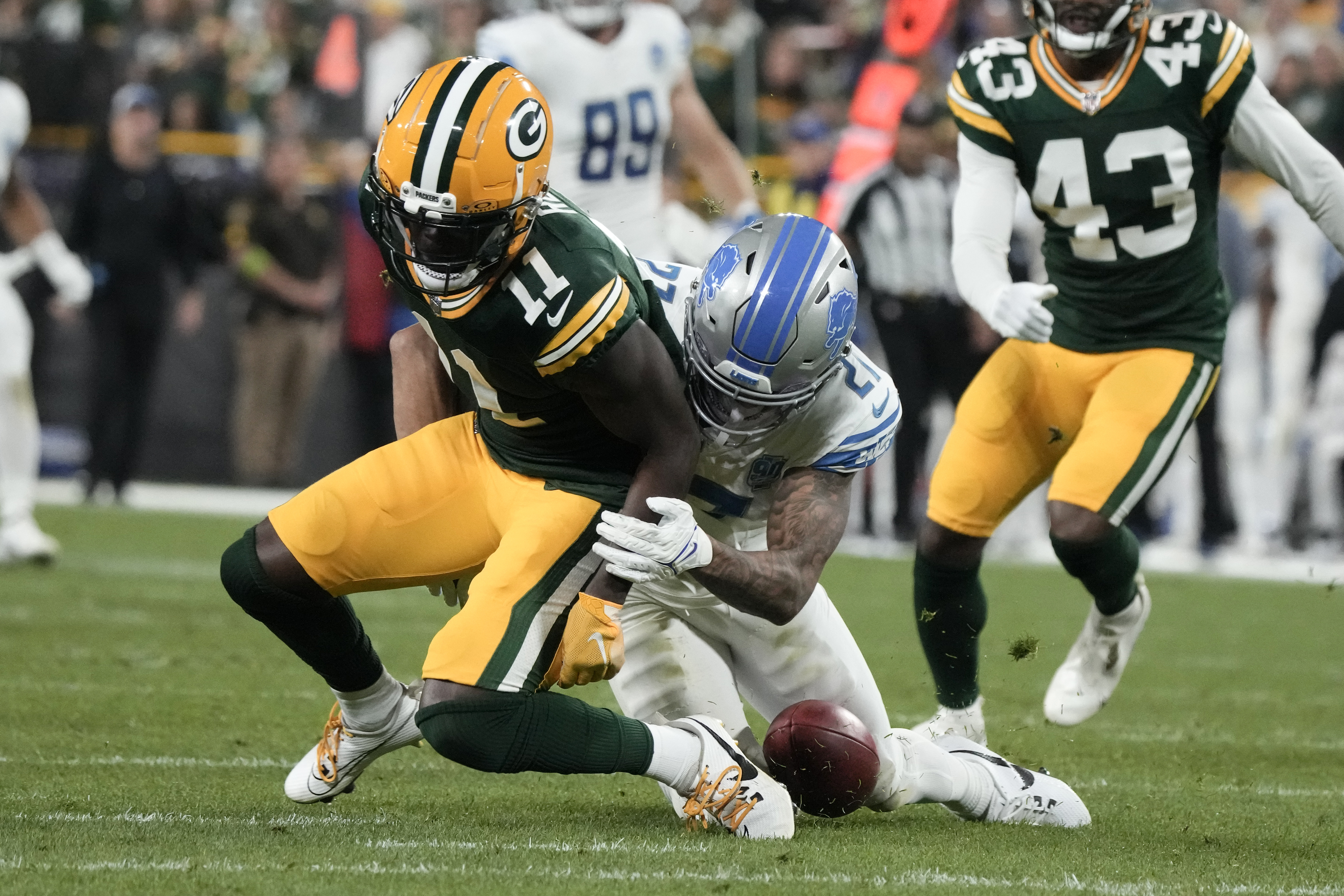 Green Bay Packers wide receiver Jayden Reed (11) scores a