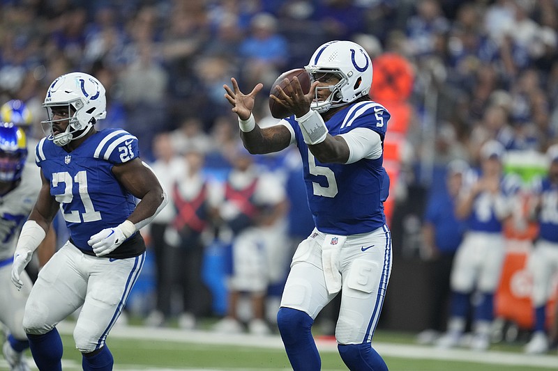 Indianapolis Colts quarterback Anthony Richardson bobbles a snap during the first half of an NFL football game against the Los Angeles Rams, Sunday, Oct. 1, 2023, in Indianapolis. (AP Photo/Michael Conroy)